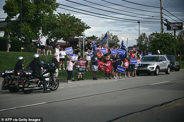 A small group of Donald Trump supporters stage a mini-rally outside Harris' event on Sunday.