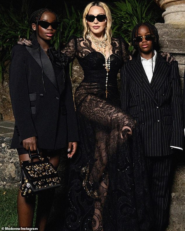 Madonna also donned a black lace dress to pose with her 11-year-old twin daughters Estere and Stella.