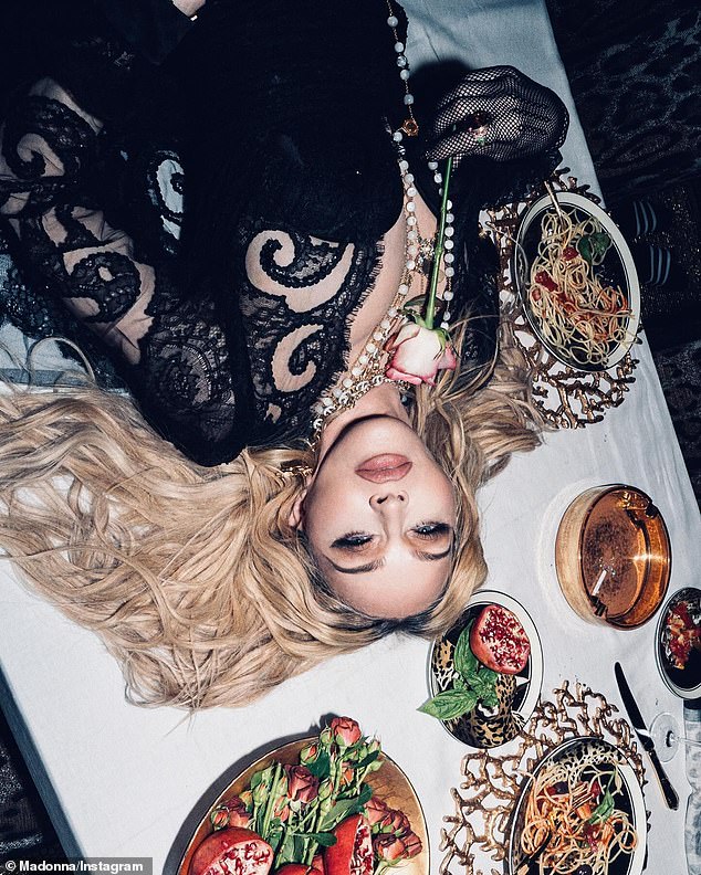 The blonde beauty looked incredible lounging at a table laden with Italian delicacies.