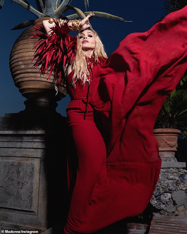 Madonna exuded glamour in her latest look: a red dress with a wavy train.