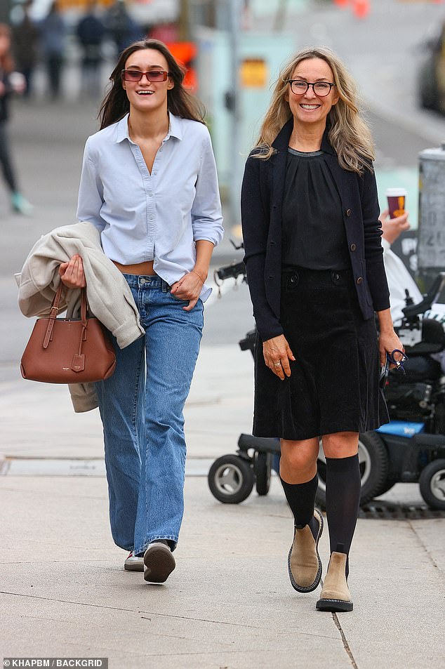 Carrying a grey jacket over her arm, Remy completed her look with a pair of old sneakers and sunglasses that matched her brown Oroton bag.