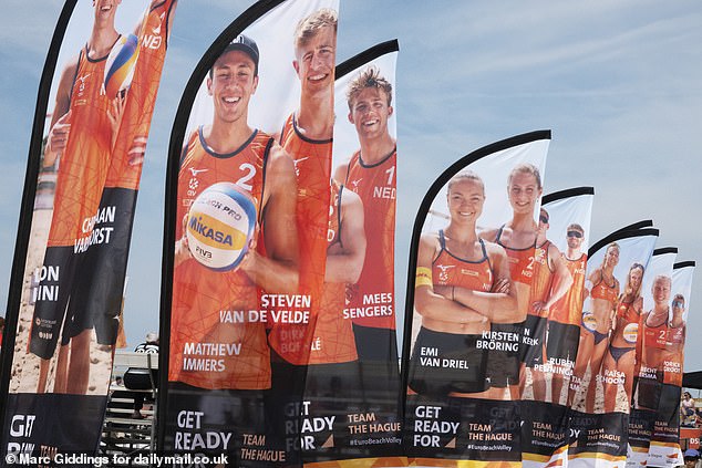 Van de Velde's image appears on the flags alongside the rest of the Dutch team at the event.