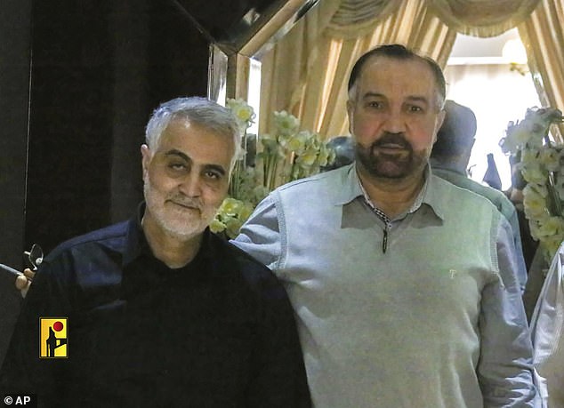 The late Iranian Revolutionary Guard General Qassem Soleimani, left, stands next to Fuad Shukr, a senior Hezbollah commander