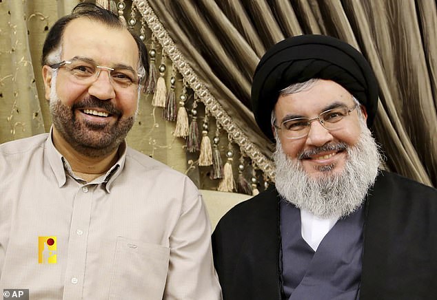 Hezbollah leader Sayyed Hassan Nasrallah, right, posing for a photo with Fuad Shukr