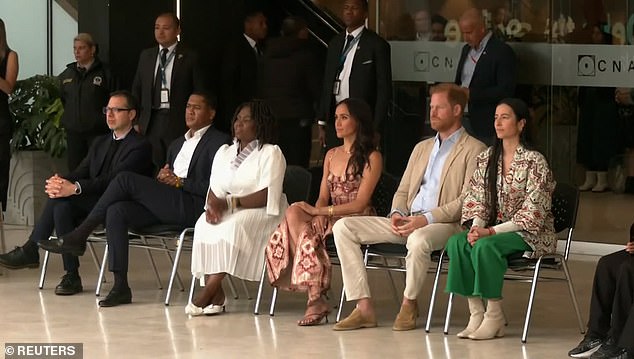 Meghan remained demure as they watched the performance and showed good posture as she appeared focused on the dance.