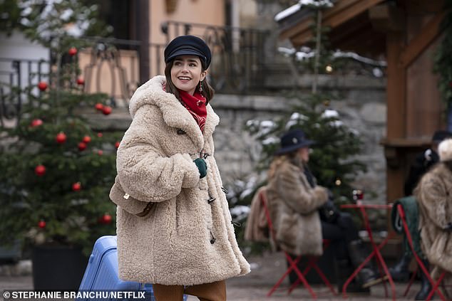 Unlike her multi-coloured faux fur creation, Emily's beige faux fur coat (pictured) is a more accessible style inspiration.