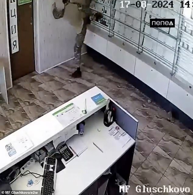 A man kicks the glass display case to steal the technology inside