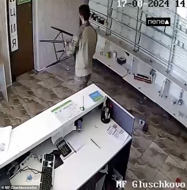 A soldier is seen using a stool to try to get through the warehouse door.