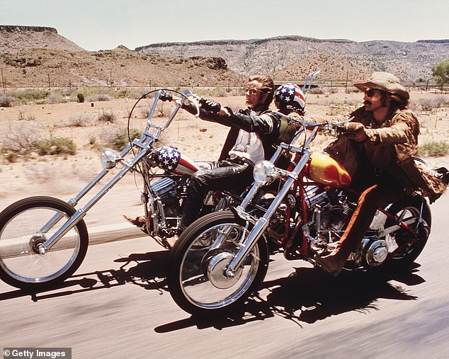 American actors Dennis Hopper and Peter Fonda ride motorcycles through the desert in a scene from the film 'Easy Rider'