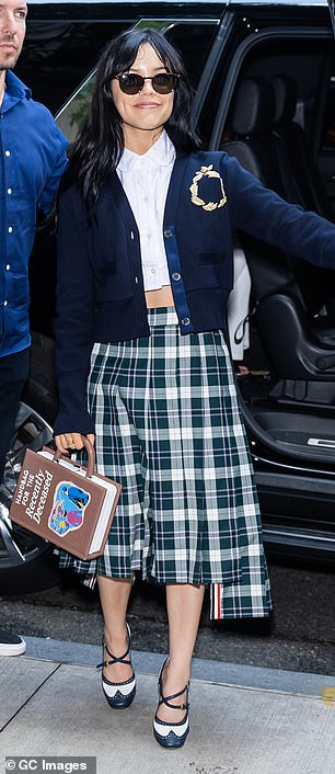 Switching things up for the third time, Jenna stepped out of a luxury black SUV wearing a long green and white plaid skirt.