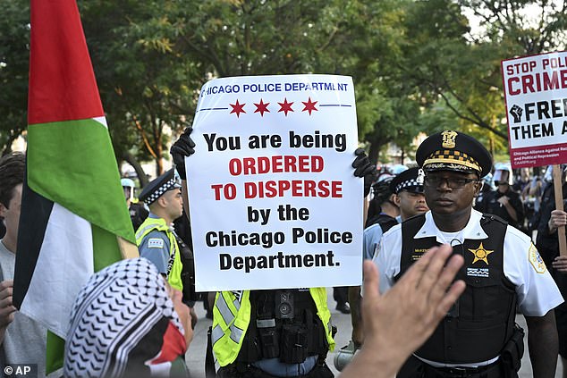 Police distribute signs calling on anti-DNC protesters to disperse