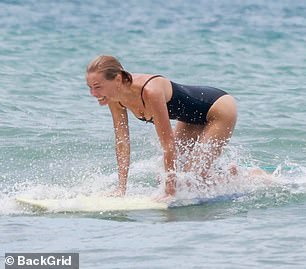 The media personality, who is married to Australian actor Sam Worthington, 48, was spotted in Costa Rica with her love as the pair went surfing.