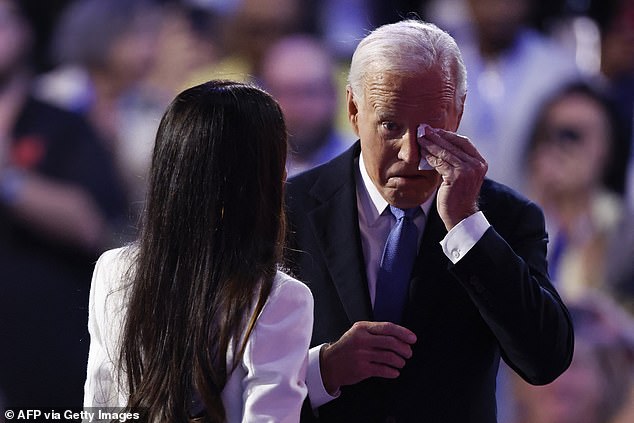 President Joe Biden (right) wipes away a tear as he arrives to deliver his farewell address at the Democratic National Convention Monday night in Chicago. He was introduced by his first daughter, Ashley Biden (left)