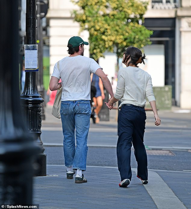 Paul also tucked a cream-colored bag under his arm during the outing.