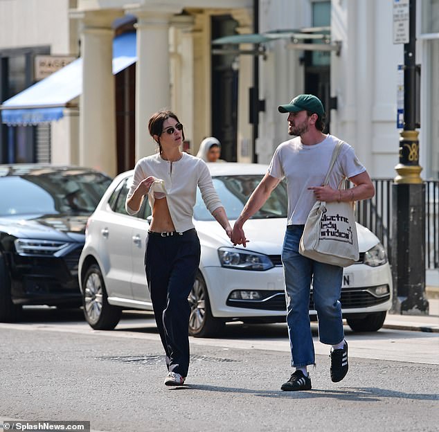 Meanwhile, Close To You singer Gracie looked casually chic in a sleek cream cardigan, with the singer at one point revealing a glimpse of her white lace bra as she lifted up her top.