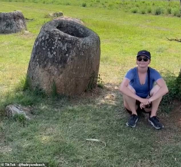 Haley is pictured above at the Plain of Jars in Laos, an archaeological landscape known for its thousands of large stone jars.