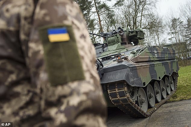 A Ukrainian soldier stands in front of a Marder infantry fighting vehicle after they were donated to kyiv last year.