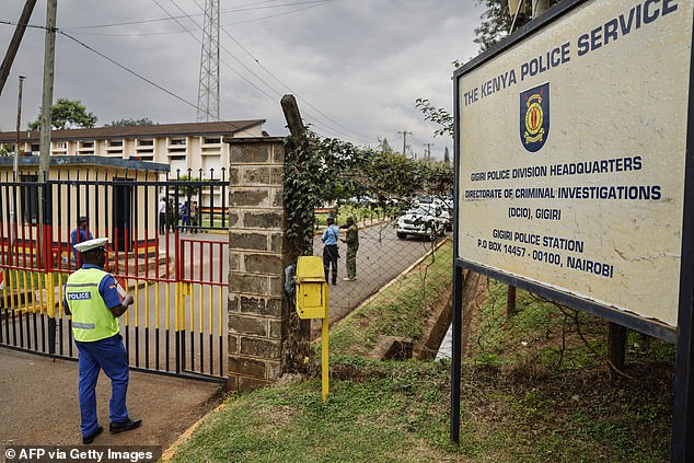 A police officer enters the Gigiri police station, after the main suspect in the Kware murder case, Collins Jumaisi, escaped from custody.