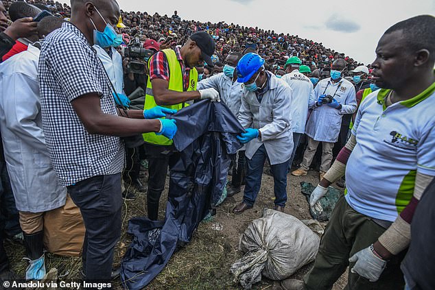 Officials inspect the bodies as a crowd of locals looks on.