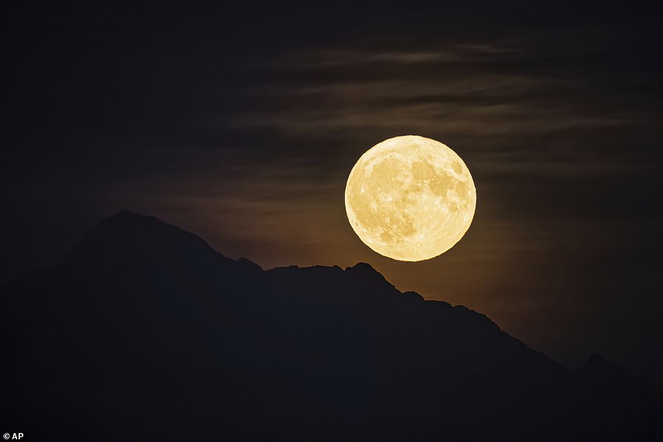 SWITZERLAND: A so-called super blue moon rises over the 