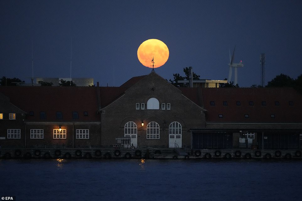 DENMARK: Supermoon over Copenhagen, Denmark. A supermoon occurs when the full moon coincides with the time of year when the Moon is closest to Earth.