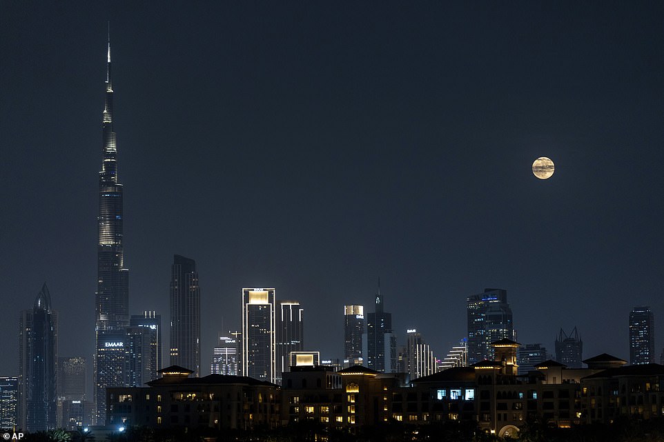 DUBAI: A look at the full moon as it rises over the city skyline with the world's tallest tower, Burj Khalifa, in Dubai, United Arab Emirates