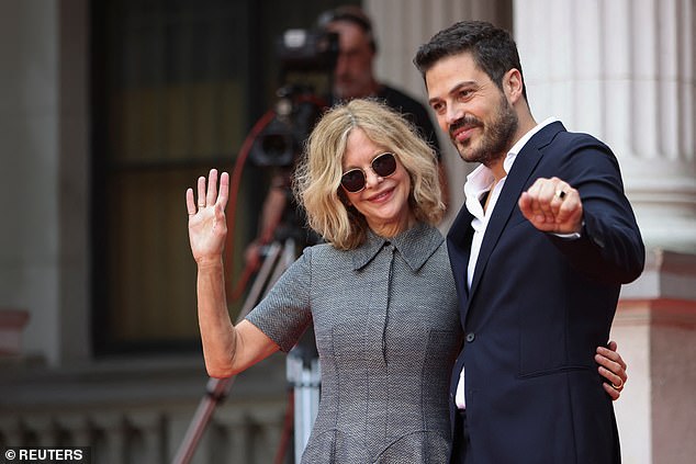 Meg radiated confidence as she walked the red carpet before taking the stage to accept her award (pictured with Jovan Marjanovic)