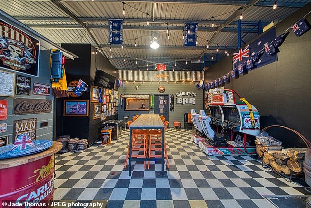 The bright red garage was transformed into 'Wrighty's Bar' with two picnic-style tables out front, checkerboard tile floors and Americana-style posters covering the walls.