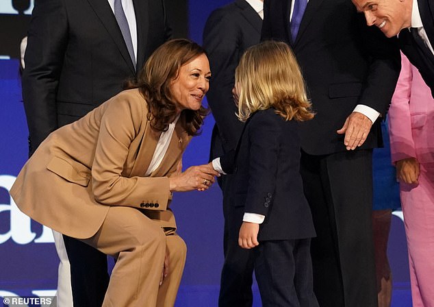 Democratic presidential candidate and US Vice President Kamala Harris greets Hunter Biden's son Beau Biden after remarks by US President Joe Biden at the Democratic National Convention