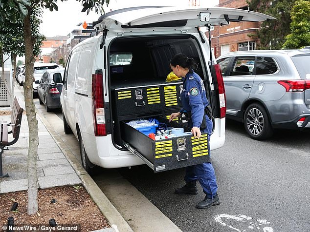 Superintendent Christine McDonald said last week that officers had recovered the suspected murder weapon from the unit (pictured, officers leave the scene in Burwood)