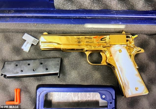 Officers attached to the Australian Border Force allegedly discovered the gold-colored Colt-45-style pistol in his luggage.