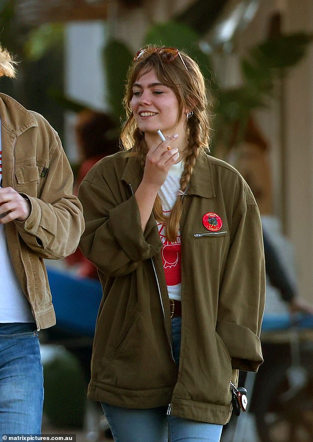 Father's favourite folk singer was seen smoking a cigarette and smiling as she joked and chatted with her friends in a fun-filled display.