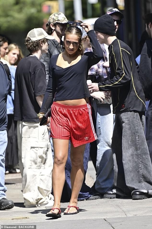 Meanwhile, McRae made sure all eyes were on her as she strutted down the pavement in a black T-shirt paired with red Adidas shorts.