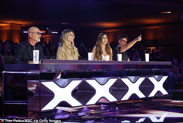 During the show, Simon reached out and tried to push Howie's Golden Buzzer for Japan's Airfootworks on Tuesday; pictured with judge Sofia Vergara