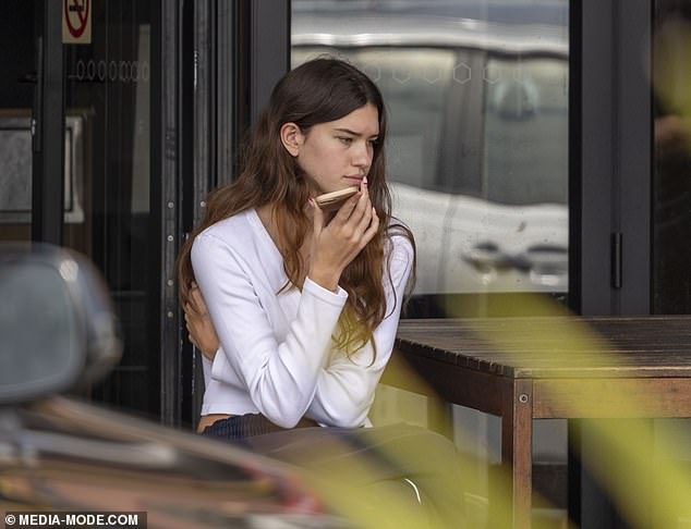 Erica's daughter Indigo (pictured) was getting into the Byron Bay boho spirit in a pair of baggy dark blue sweatpants and a white long-sleeved T-shirt that ended at the midriff.