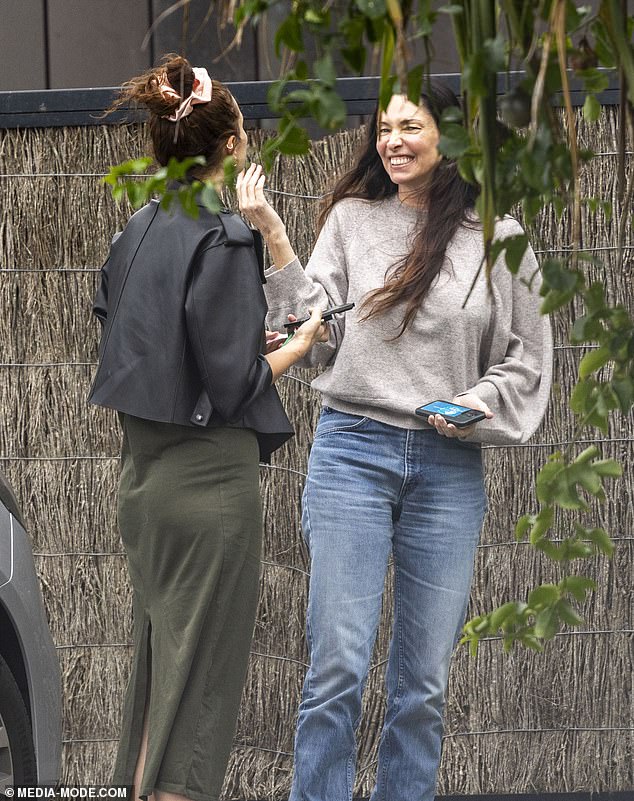 Erica seemed to be having a great time in the seaside village, chatting happily with a friend on the street.