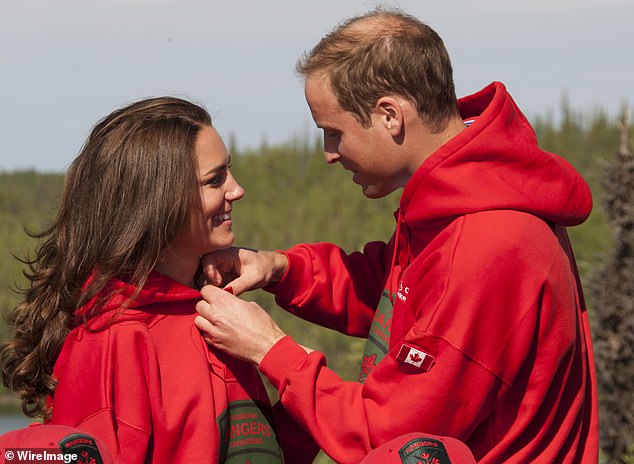 Prince William of Wakes fastens Kate's top button during their first official visit abroad since their wedding in 2011