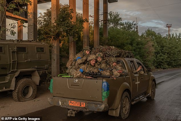 Ukrainian soldiers drive a vehicle in an undisclosed area of ​​the eastern Donetsk region, August 5, 2024.