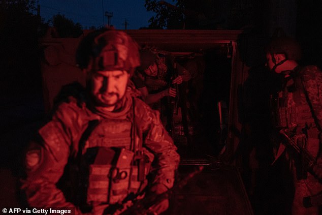 Ukrainian soldiers arriving from the front disembark from a US-made M113 armored personnel carrier in an undisclosed area in the eastern Donetsk region, August 5, 2024.