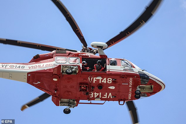 A firefighting helicopter is flying over Porticello today as the search operation gets underway.