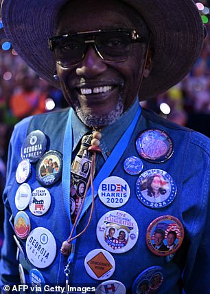 A delegate wearing pins on his vest, including President Biden, Harris, former Democratic presidents, and the battleground state of Georgia