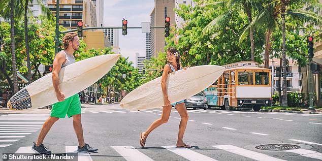 Hawaii is also on sale with a one-way ticket from Sydney for just $280 (file photo of tourists in Honolulu)