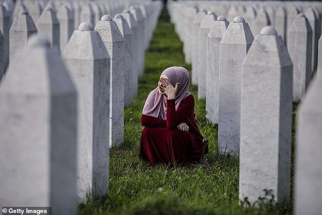 A Bosnian Muslim woman cries among the graves of her father, two grandfathers and other close relatives, all victims of the Srebrenica genocide, on July 10, 2020, at Potocari cemetery near Srebrenica, Bosnia and Herzegovina. More than 8,000 Bosnian Muslim men and boys were killed after the Bosnian Serb army attacked Srebrenica, a UN-designated safe zone, on July 10 and 11, 1995, despite the presence of UN peacekeepers.