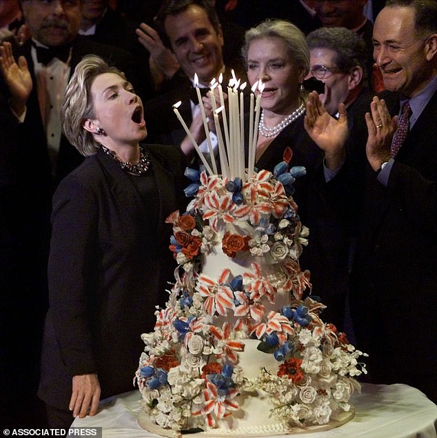 Former US Secretary of State Hillary Clinton is seen celebrating her birthday in October 1999 as she takes a deep breath to blow out the numerous candles.