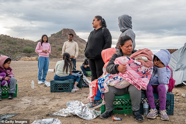 Mexican migrant Veronica Marquez, 36, comforts her son Mariano, 5, as she waits to be detained by U.S. Customs and Border Protection officers after crossing into the United States on June 25, 2024.