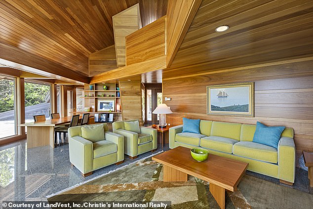 The 4,963-square-foot home is located on Buckmaster Neck in Stonington and was designed by local architect James W. Schildroth (pictured: the living room and dining room)