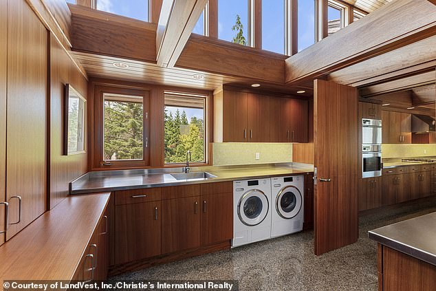 Right next to the entrance door is a spacious laundry room equipped with a washing machine and dryer and plenty of storage space (pictured)