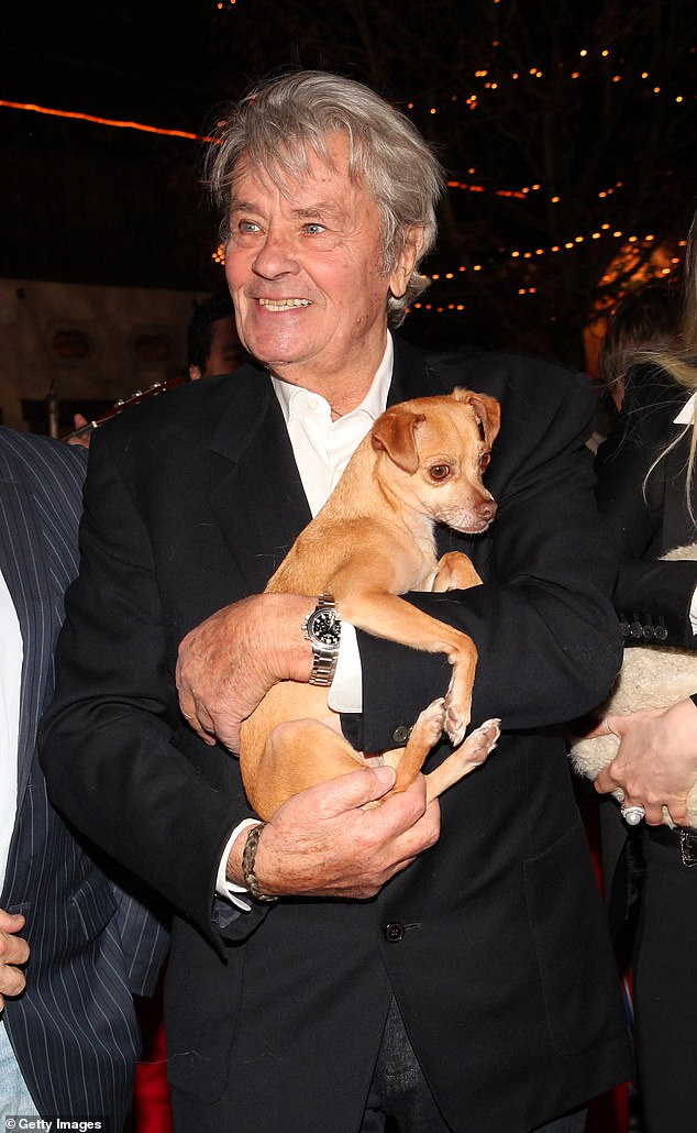 Alain Delon (pictured with another dog in 2014) said he wanted Loubo, his now 10-year-old Belgian Malinois, to be put down and buried with him.