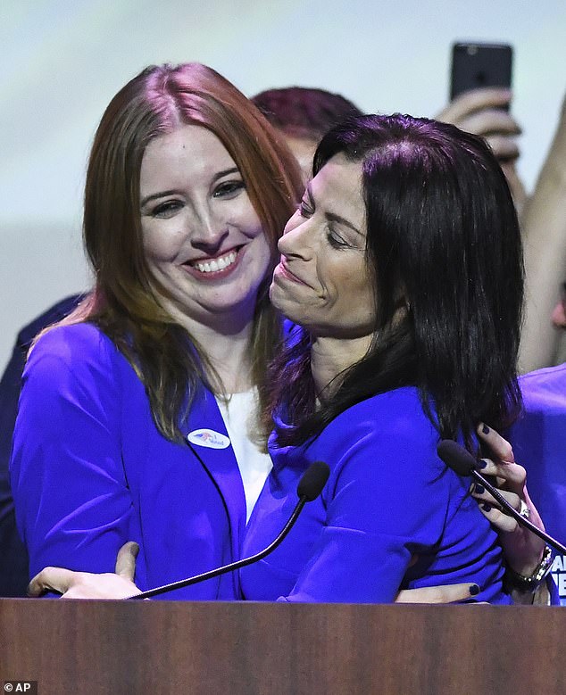 Nessel, right, hugs his wife, Alanna Maguire, at the Michigan Democrats' election night party in Detroit on Tuesday, Nov. 6, 2018.