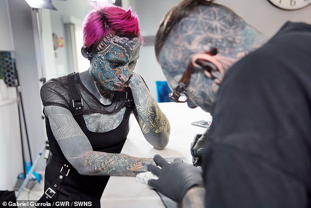 Esperance (pictured getting a tattoo) attracts stares and attention from people when she goes out and finds it difficult to receive negative responses from people.